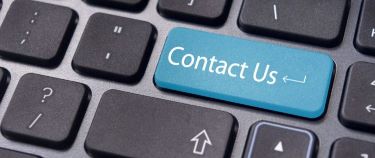 Close-up of a keyboard with a blue key labelled 'Contact Us,' symbolising communication and support services at Penk Valley Academy Trust.