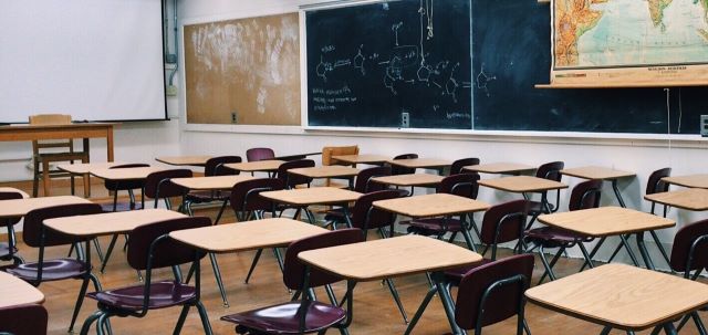 Classroom interior showing desks and chairs in a school setting